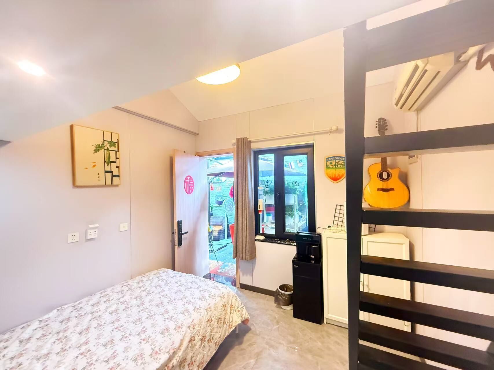 A bedroom with a bed, a window, a door, and a bunk bed.