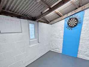 A room with a dartboard, a whiteboard with names and numbers, and a window. - 3 bedroom accommodation in Fraserburgh (Fraserburgh)