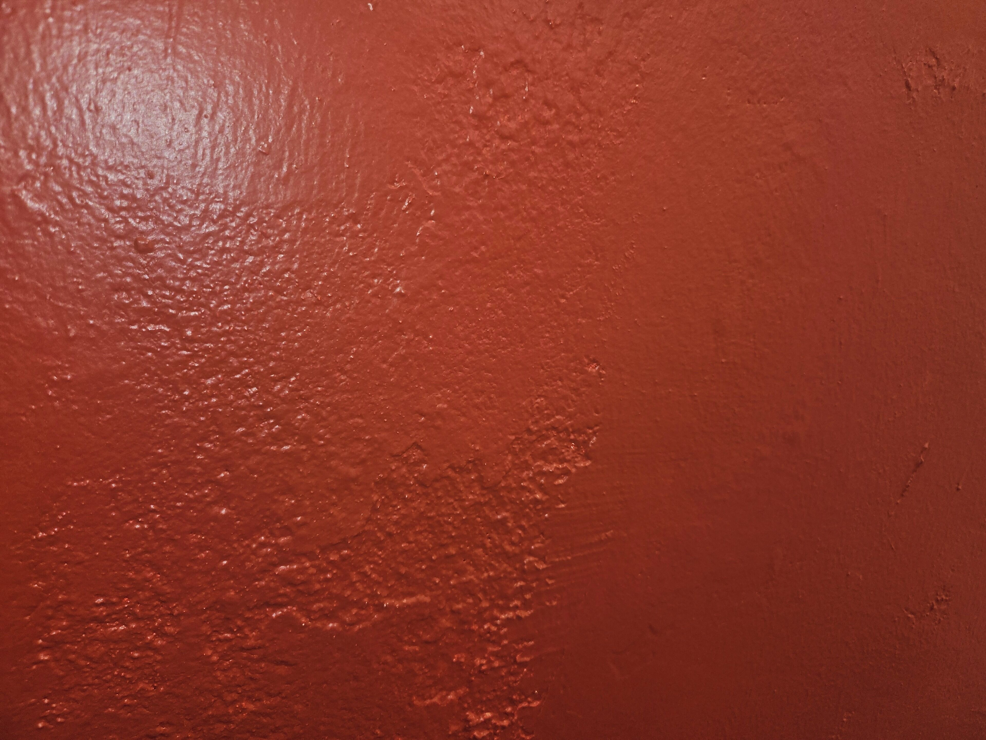 A close-up of a textured surface with a reddish-brown color.