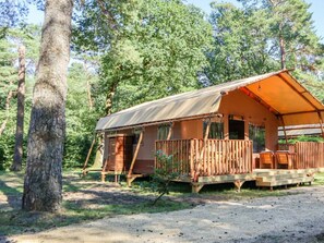 A rustic cabin with a wooden deck, a covered porch, and a gravel driveway. - Holiday Home in Otterlo With Terrace (Otterlo)