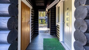 A log cabin with a wooden door, a window, and a door with a small window. - Villa Succa (Kittilä)