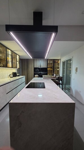 A modern kitchen with a central island, built-in appliances, and a sleek design. - Luxurious Contemporary Villa with Private Pool in Tunis (Tunis)
