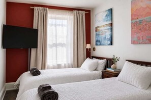 A hotel room with two beds, a TV mounted on the wall, a window with curtains, and artwork on the walls. - Fifa Stay Walk Manayunk River 4 Beds Sleeps 6 (Philadelphia)