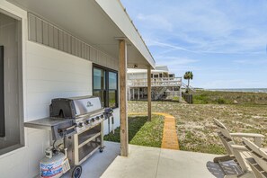 A barbecue grill, a concrete patio, a wooden deck, and a view of the beach and ocean. - Casa Del Mare | Beach to Bay on Alligator Point (Alligator Point)