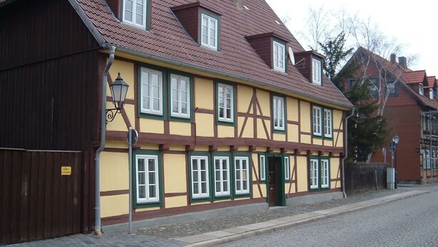 A traditional half-timbered building with a cobblestone street. - Maria Apartment 2 – Stay in the Heart of Wernigerode (Wernigerode)