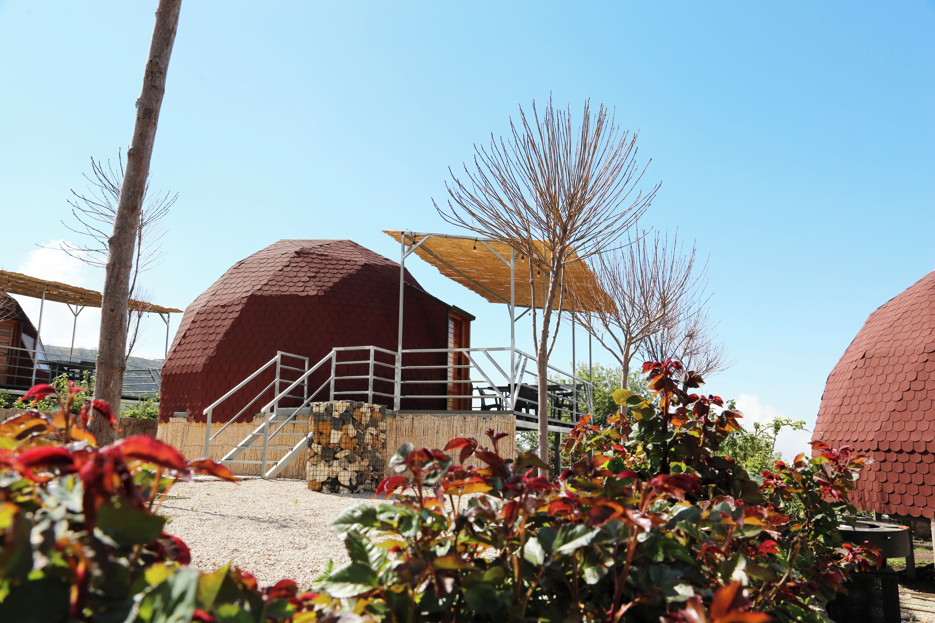A building with a dome structure, a staircase, and a covered area with a yellow canopy.