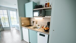 A modern kitchen with a dishwasher, a microwave, and a sink.