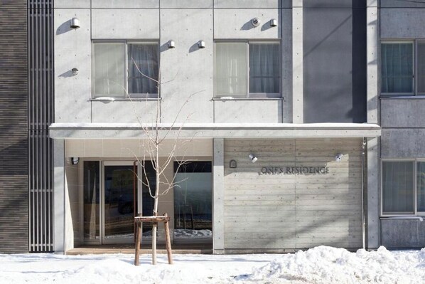 A modern building with a flat facade, large windows, and a sign reading 'ONE'S RESIDENCE.' - ONESCLarge Twin Room / Sapporo Hokkaidō (Sapporo)