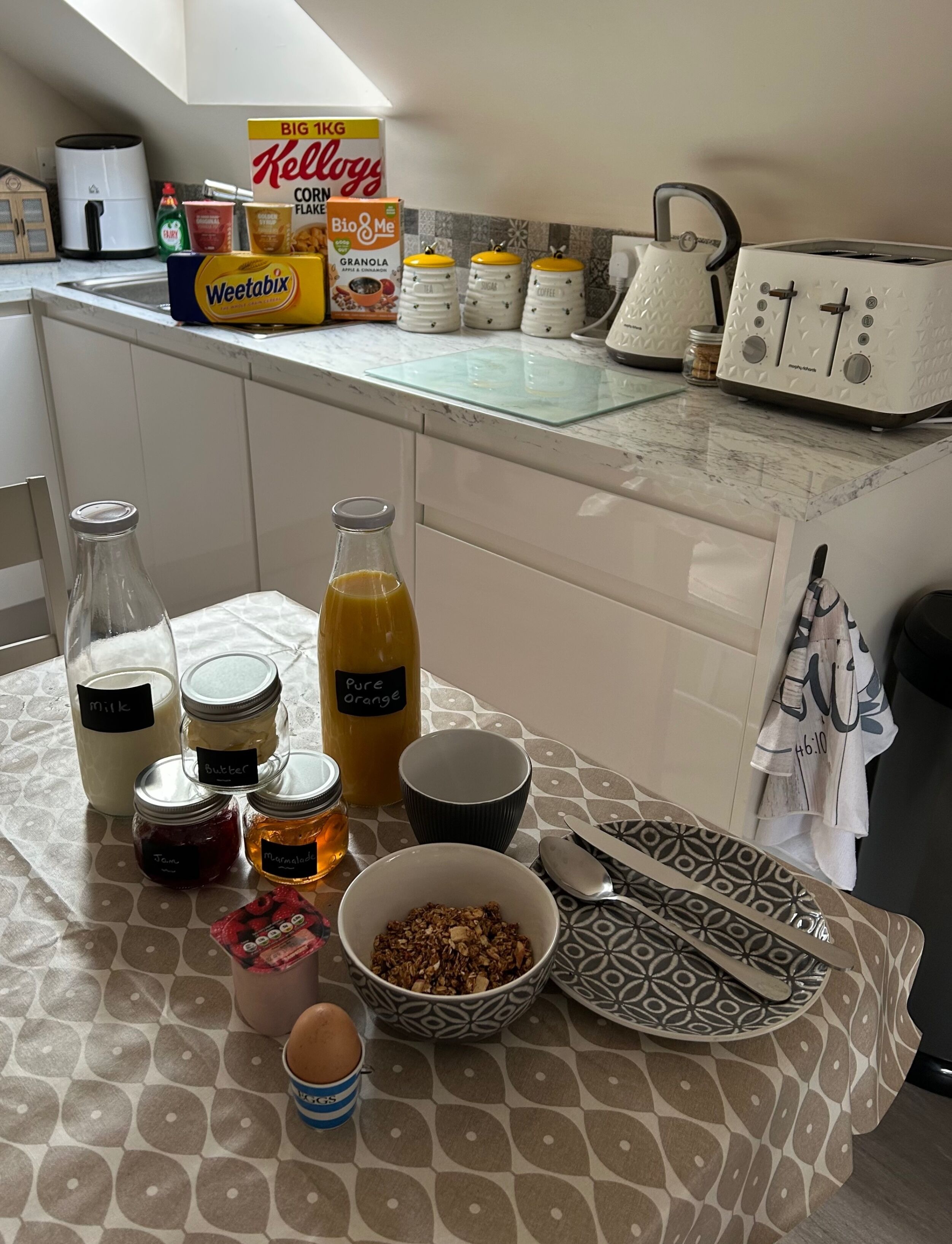 A kitchen counter with various food items and kitchen appliances.