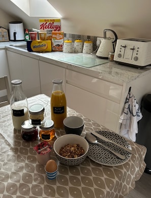 A kitchen counter with various food items and kitchen appliances. - Omagh Studio b&b With Light Breakfast Inc (Omagh)