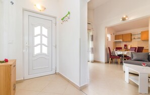 A modern apartment with a dining area, kitchen, and a living room. - Stunning home in Pula with private swimming pool, can be inside or outside (Pula)