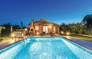 A swimming pool with a tiled deck, a lounge chair, and a stone fireplace. - Stunning home in Pula with private swimming pool, can be inside or outside (Pula)