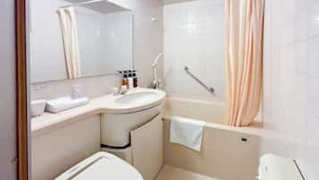 A bathroom with a toilet, sink, mirror, and bathtub.