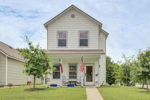 A two-story house with a porch, two flags, and a small tree in the yard. - < 1 Mi to Georgetown Square & SU! Extended Base (Georgetown)