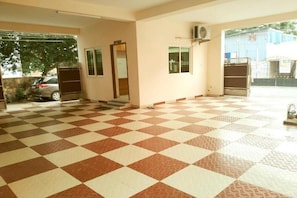 A spacious indoor area with a checkered floor, a door, and a window.