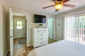 A bedroom with a bed, a dresser, a television, and a ceiling fan. - Walk to Beautiful & Historic Downtown Mount Dora (Mount Dora)