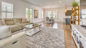 A spacious living room with a sofa, coffee table, and dining area. - Close to Beach! Miramar Beach Haven w/ Pool Access (Miramar Beach)
