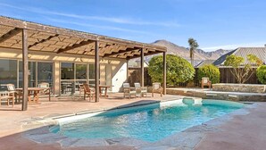 A pool area with lounge chairs and a covered patio. - Mountain Four-Guest with Views (Wanaka)