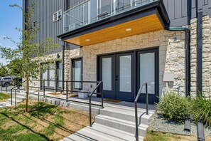 A modern building with a stone facade, large windows, and a wooden overhang. - Walkable Location: Pet-Friendly Denver Townhome (Denver)