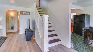A staircase leading to a second floor, a kitchen area with a refrigerator, and a sign that says 'gather' on the wall. - 14 Mi to Pittsburgh: Clairton Trailside Retreat (Clairton)