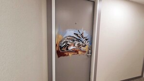 A door with a mural of a deer. - Jackalope Loft in Downtown Custer #2 (Custer)