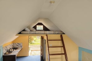 A room with a sloped ceiling, a built-in bench with cushions, a ladder, and a small window. - Cozzy Villa Sabda Desa Cabin (Pangalengan)