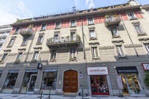 A multi-story building with storefronts, including 'igiornidi carta' and 'VESTOPAZZO.' - 81 Garibaldi – Brera Base   (Milan)
