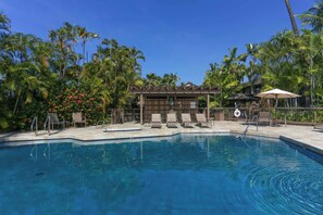 A swimming pool with lounge chairs and a covered seating area surrounded by palm trees. - Partial Ocean View Suite w/Full Kitchen, W/D, WiFi, Lanai, TV Kanaloa 3401 (KAILUA-KONA)