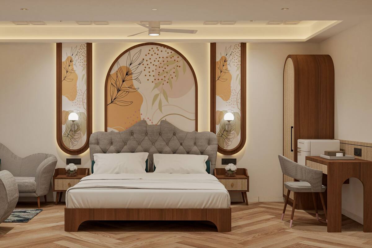A modern bedroom with a tufted headboard, a wooden desk, a chair, and a bed with white bedding.