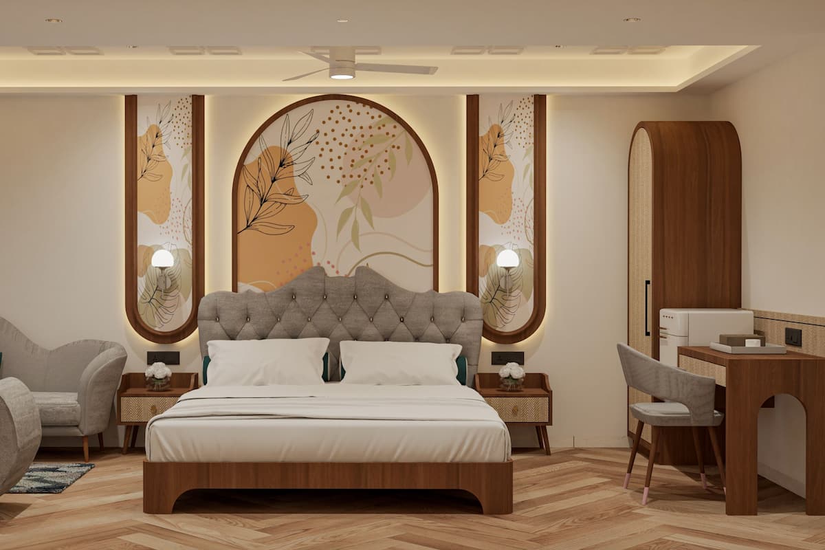 A modern bedroom with a tufted headboard, a wooden desk, a chair, and a bed with white bedding.