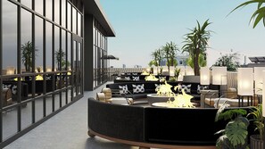 A rooftop lounge with seating areas, a central fire feature, and potted plants. - Holiday Inn & Suites Tijuana Downtown by IHG (Tijuana)