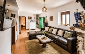 A living room with a sofa, coffee table, and decorative items. - Gorgeous home in Pizarra with private swimming pool, can be inside or outside (Pizarra)
