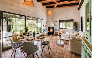 A spacious living area with a fireplace, dining table set for four, and a cozy seating arrangement. - Amazing home in Tarifa with WiFi (Tarifa)