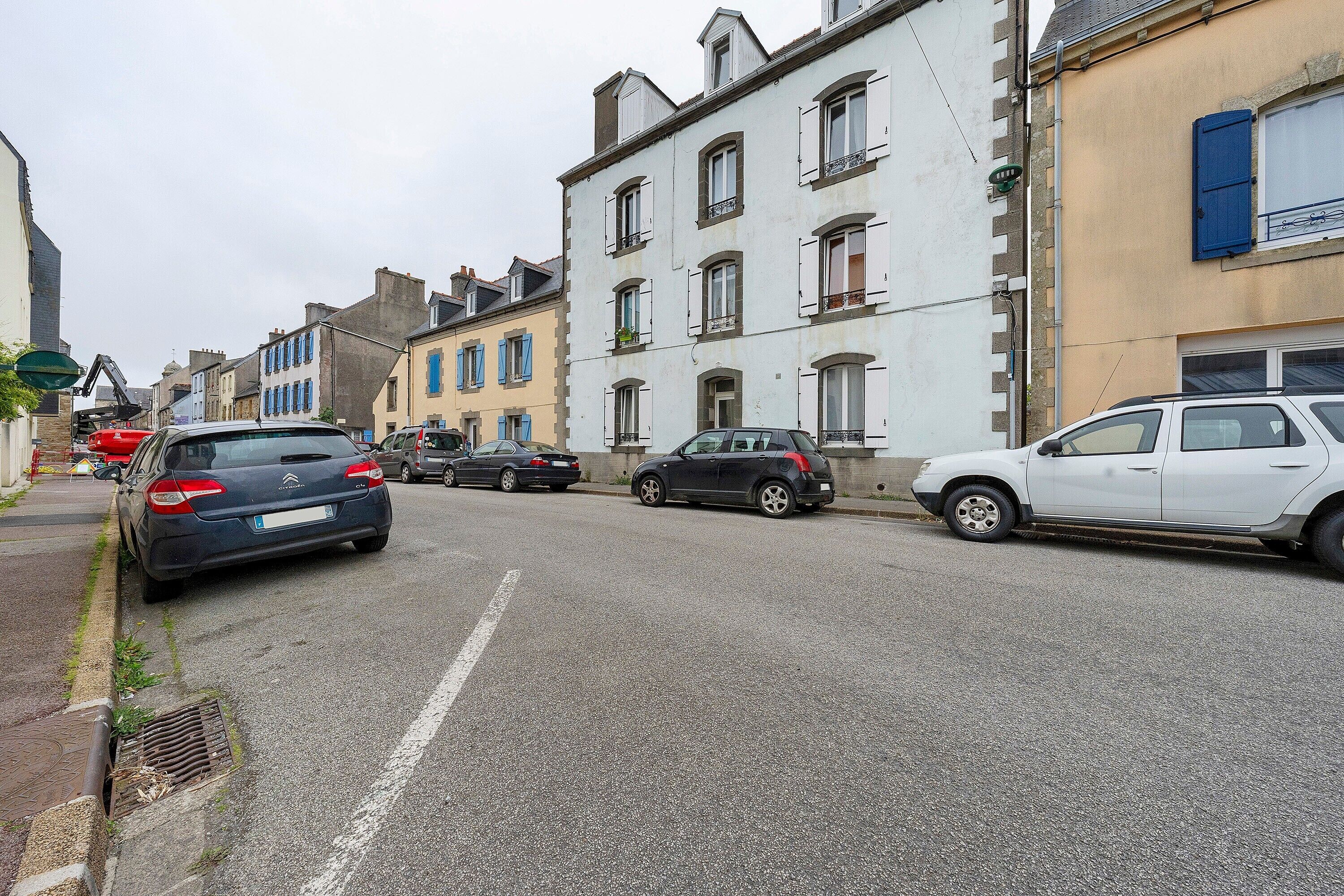 A street with parked cars and buildings.
