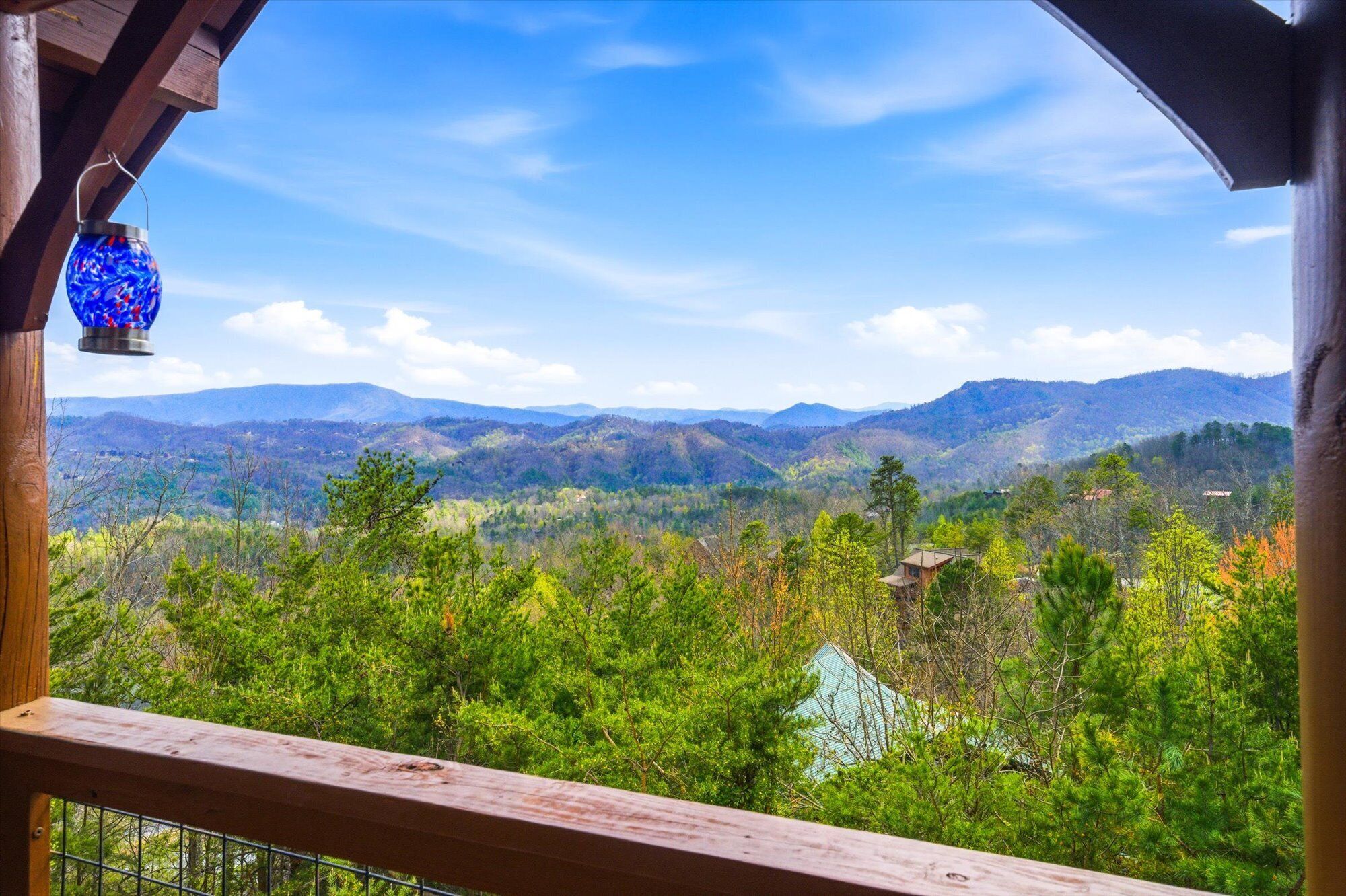 A balcony with a view of a mountainous landscape.