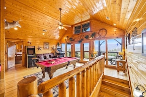A wooden cabin with a pool table, a bar area, and a view of the mountains. - Red, White and The View (Sevierville)