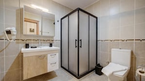 A bathroom with a vanity, a toilet, a shower enclosure, and a mirror. - Lagoonia Sun Boutique Hotel (Ölüdeniz)