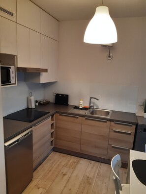 Eine moderne Küche mit eingebauter Mikrowelle, Spüle und Geschirrspüler.