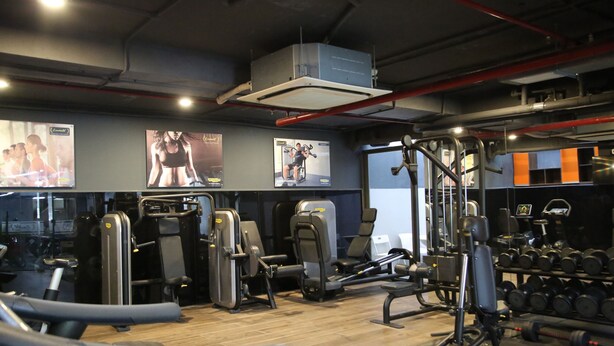 A gym with various exercise equipment, including treadmills, weight machines, and dumbbells. - CityHouse TERA Emerald (Ho Chi Minh City)