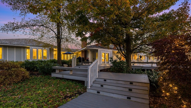 A residential property with a wooden deck, a small porch, and a well-lit house. - Kateri (Waynesboro)