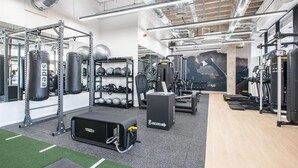 A gym with weightlifting equipment, treadmills, and a punching bag. - Station Noir Stylish 1-bed in Central MK (Milton Keynes)