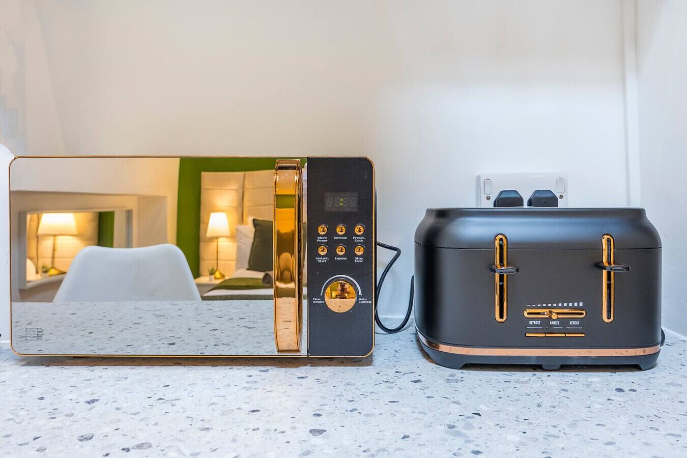 A modern kitchen with a microwave and toaster on a countertop.