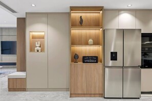 A modern kitchen with a stainless steel refrigerator, wooden cabinets, and a sign labeled 'UTENSILS'. - FIRST CLASS |2BR| Scenic View w/ JBR Beach Access (JBR)
