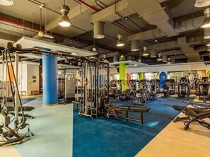 A gym with various exercise equipment, including weight machines and cardio machines. - FIRST CLASS |2BR| Scenic View w/ JBR Beach Access (JBR)