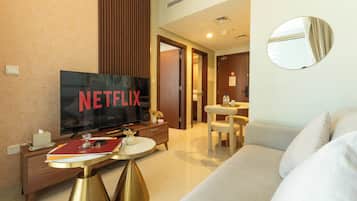 Deluxe Apartment, Balcony, Lake View | Living area | 130-cm Smart TV with satellite channels