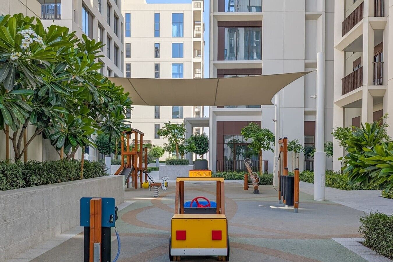 A children's play area with a slide, a small climbing structure, and a toy car.