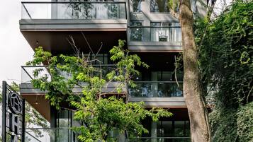 A multi-story hotel with a modern design, featuring balconies and large windows.