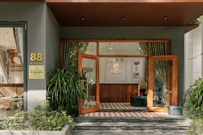 A hotel entrance with a number '88' sign, a wooden frame, and a signboard with 'HAKU BOUTIQUE HOTEL' written on it. - HAKU Boutique Hotel Da Lat - Ly Tu Trong (Xuan Huong - Da Lat)