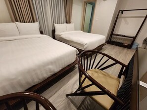 A hotel room with two beds, a wooden chair, and a small table. - HAKU Boutique Hotel Da Lat - Ly Tu Trong (Da Lat)