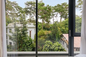 A view from a window with a view of a building surrounded by trees. - HAKU Boutique Hotel Da Lat - Ly Tu Trong (Xuan Huong - Da Lat)